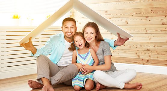 concept housing   young family. Mother father and child in new house with  roof