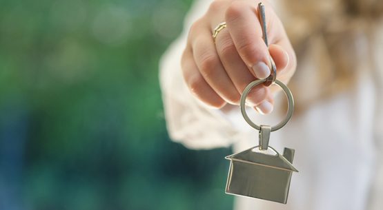 Real estate agent handing over the keys to a home.